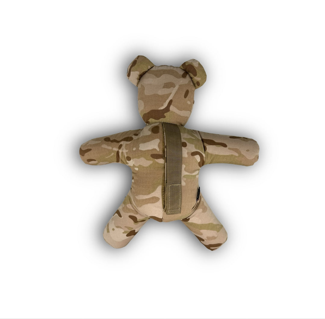 Camouflage-patterned teddy bear with a strap on a white background