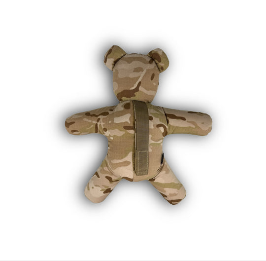 Camouflage-patterned teddy bear with a strap on a white background