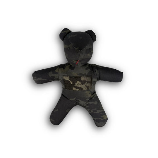 Camouflage-patterned teddy bear on a white background